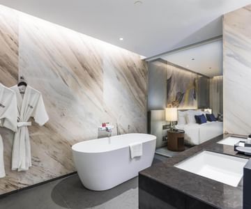 Bathtub with two bathrobes at Chatrium Grand Bangkok