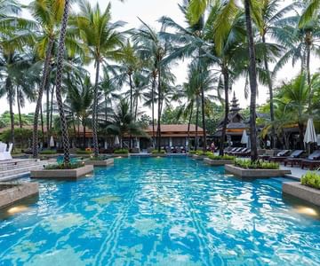 Palm trees near the pool at Chatrium Hotel Lake Yangon