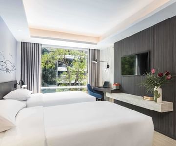 A room with two beds at Maitria Hotels & Residences