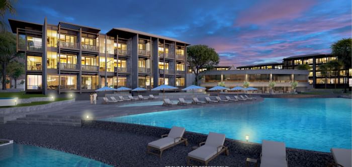 Pool area with pool chairs at Chatrium Hospitality